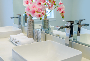 a clean and tidy bathroom sink with flowers